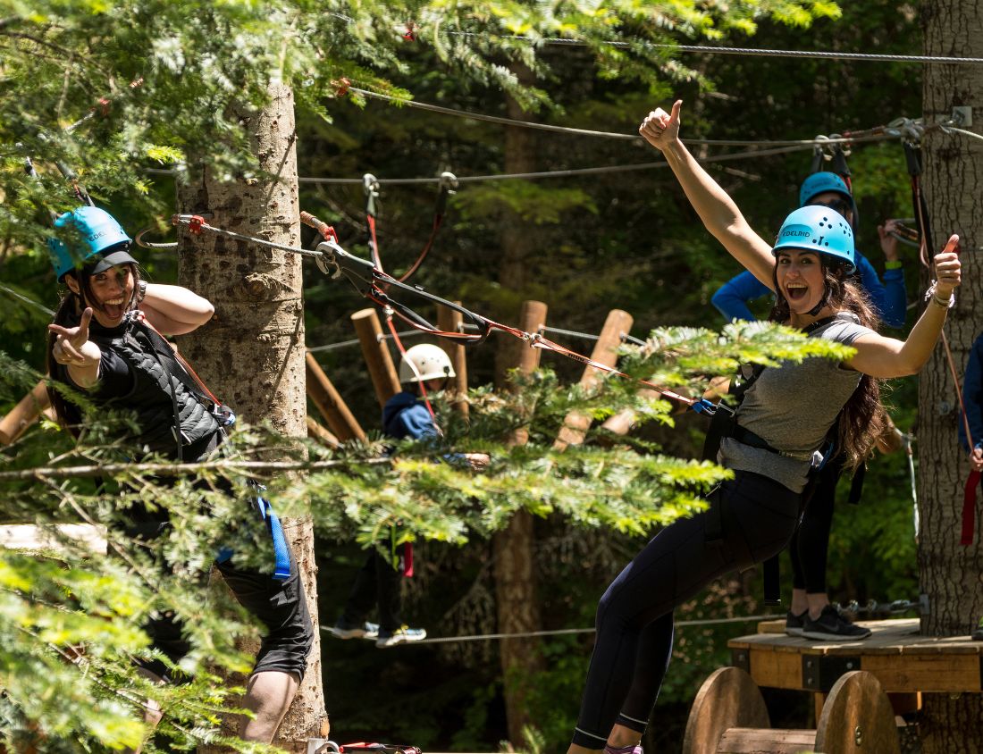 Two ladies in the trees in Washington State on an aerial park tour.