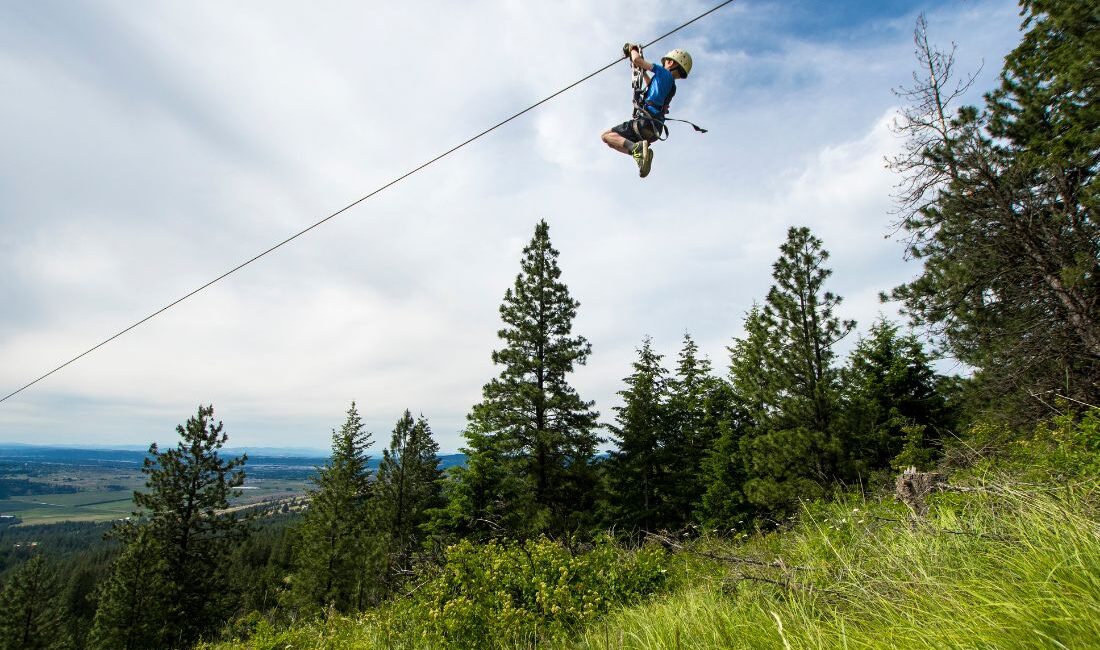 kid zipping on zipline in spokane