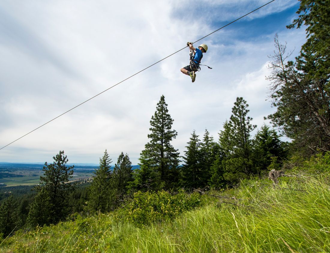 kid zipping on zipline in spokane